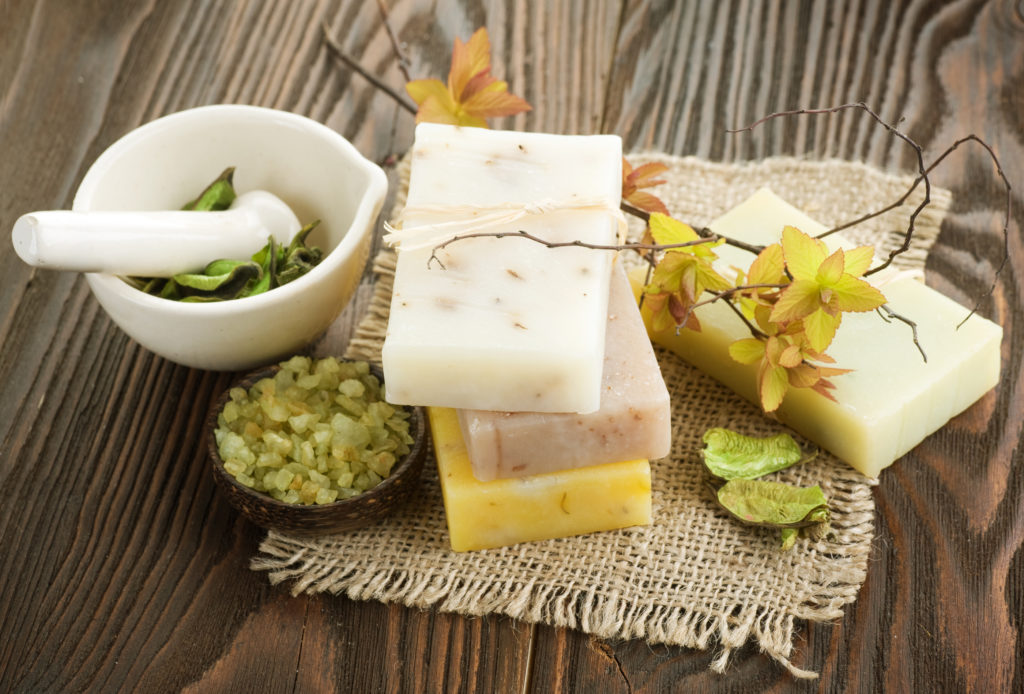 Handmade Soap with natural ingredients over wooden background